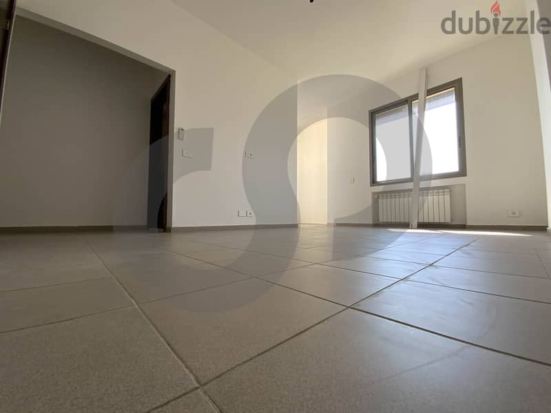 This spacious, well-lit apartment in Horsh Tabet   REF#SB97412 12