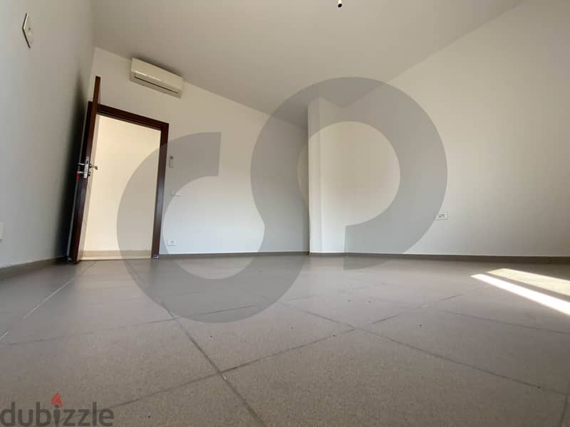 This spacious, well-lit apartment in Horsh Tabet   REF#SB97412 13