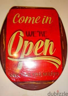 Decorative toilet seat cover "come in we re open" by home creation