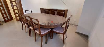 Antique large dining table with 10 chairs and a dresser