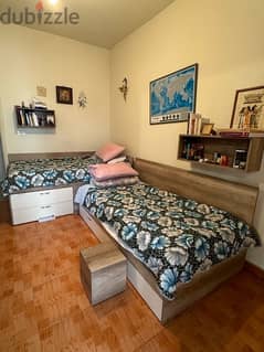 2 beds with mattresses and 5 wall units.