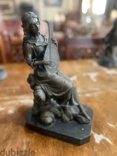 bronze piece girl with musical instrument