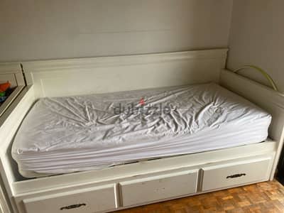 White bed with mattresse and a openable drawer