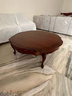 Round brown oak table for salon