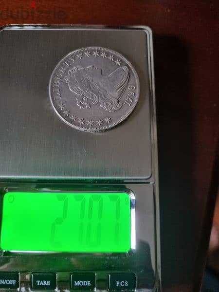 A silver old coin 7 dollars the gram 7