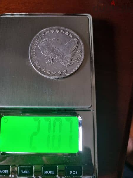 A silver old coin 7 dollars the gram 8