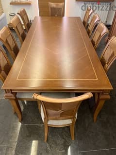 Wood dining table accompanied with 10 chairs in very good condition 0