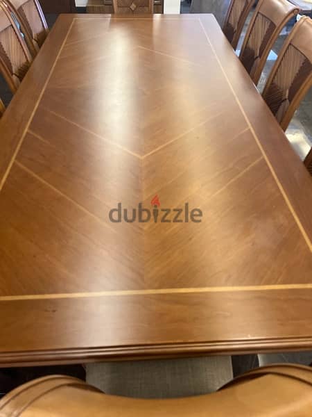 Wood dining table accompanied with 10 chairs in very good condition 1