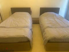 two beds with commode