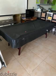 billiard table with cover, balls, and everything