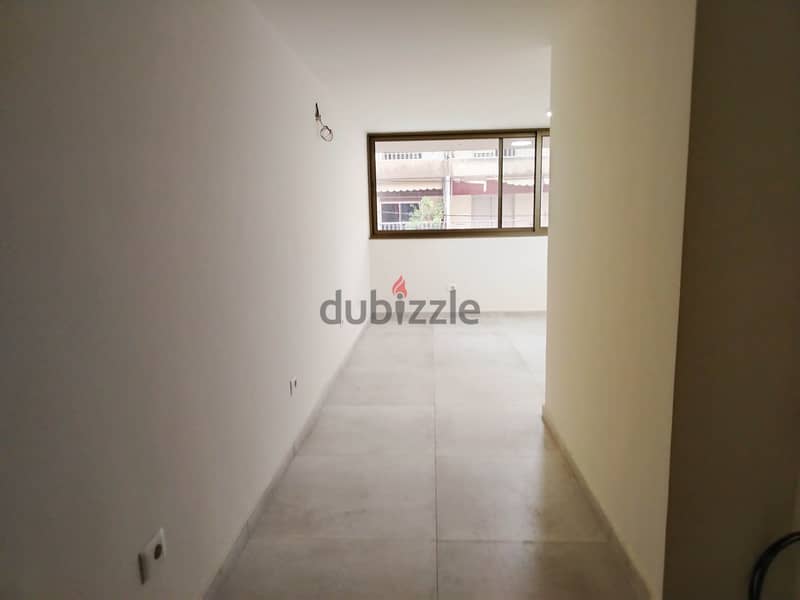 125 SQM Prime Location Shop in Dekwaneh, Metn 1