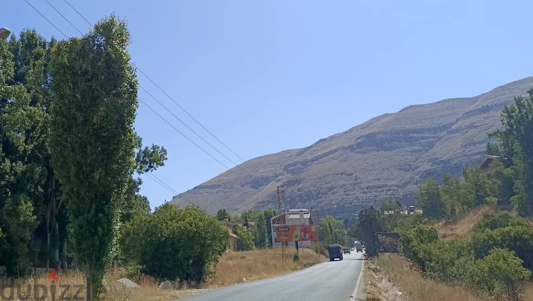 Land on Tilal El Aassal highway for sale 1