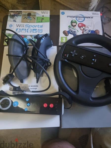 Nintendo wii with 2 remotes and 2 cds Mario kart and wii sports 0