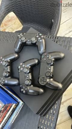 ps4 pro with 12 games + 4 original controllers