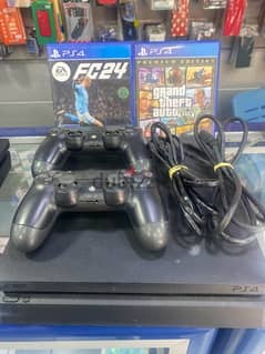 ps4 slim with 2 controllers one original and 2 cd gta5 & fc 24