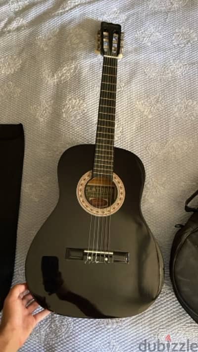 brand new acoustic guitar black used once with a stand for notes