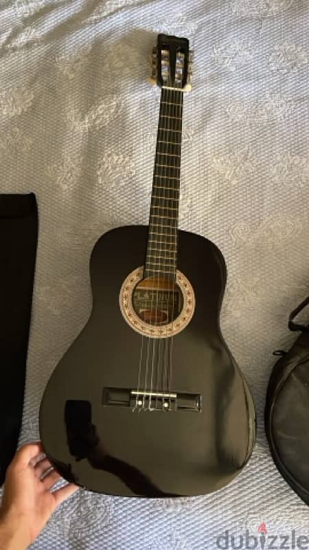 brand new acoustic guitar black used once with a stand for notes 0