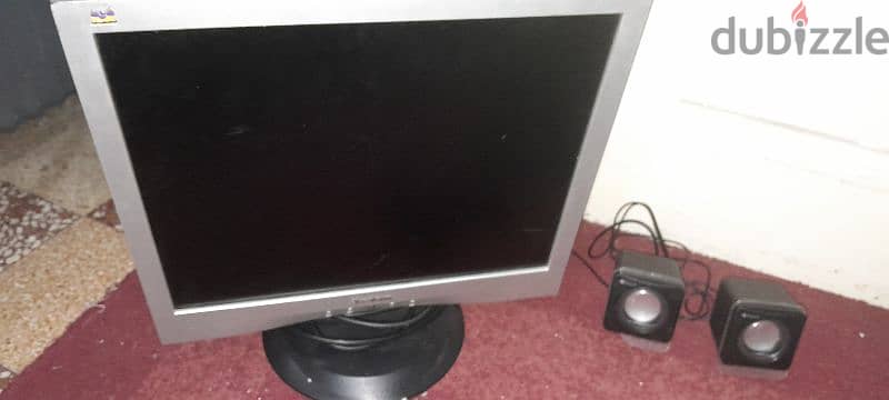 Computer screen with computer speakers and PlayStation controller USP 2