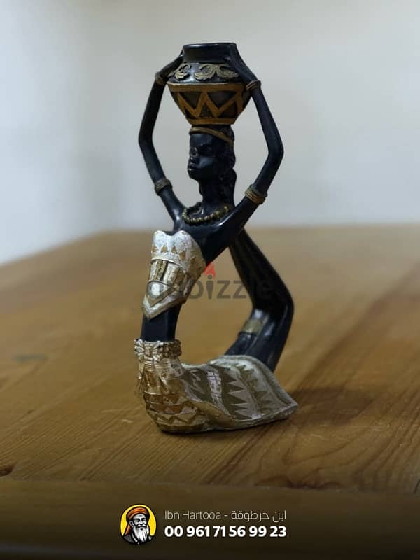 African figurine of a woman with a water bucket 0