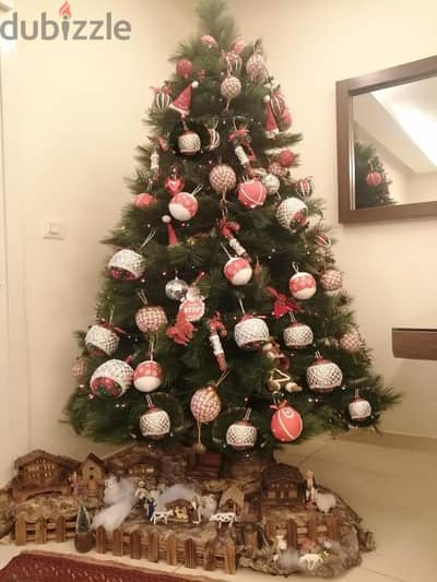 a Christmas tree for sale with it's decoration