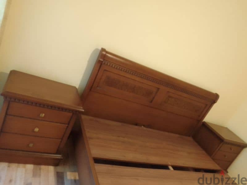 large bed with two small commodes 0