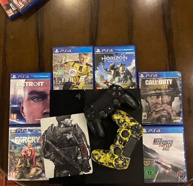 Ps4 with 2 controllers and 7 games 0