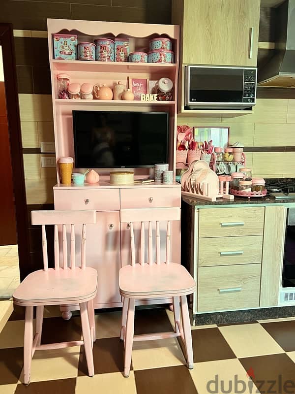 kitchen pink vintage cupboard and two vintage chairs. 0