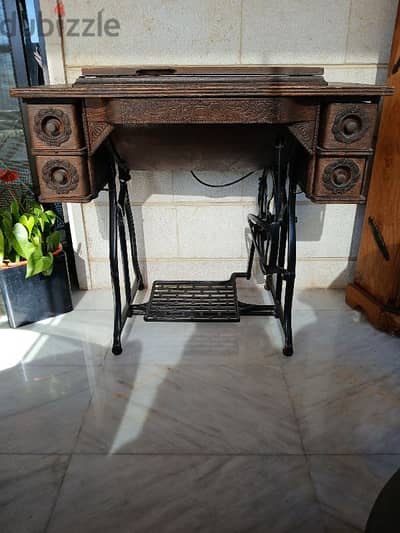 Antique sewing machine with wooden top