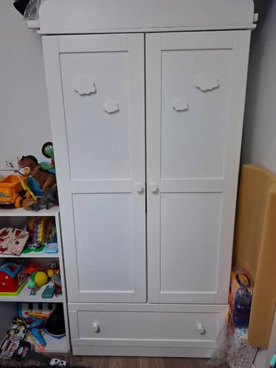 Bed, white baby dresser with changing table, and wardrobe.