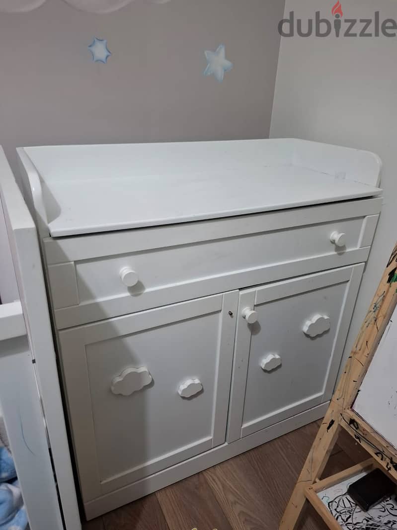 Bed, white baby dresser with changing table, and wardrobe. 1