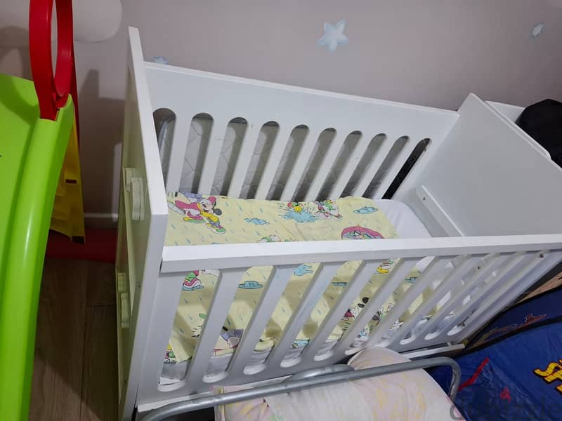 Bed, white baby dresser with changing table, and wardrobe. 2