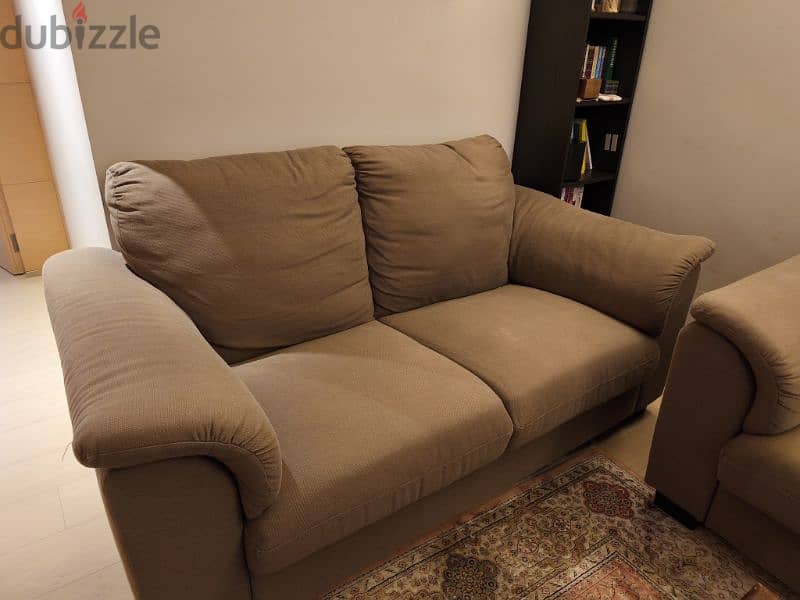 a pair of brown sofas 1