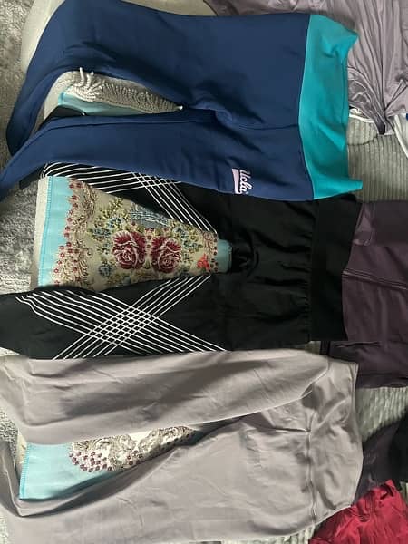 12 shirts  and 3 used like new gym sports shirts and pants size small 2