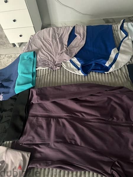 12 shirts  and 3 used like new gym sports shirts and pants size small 4