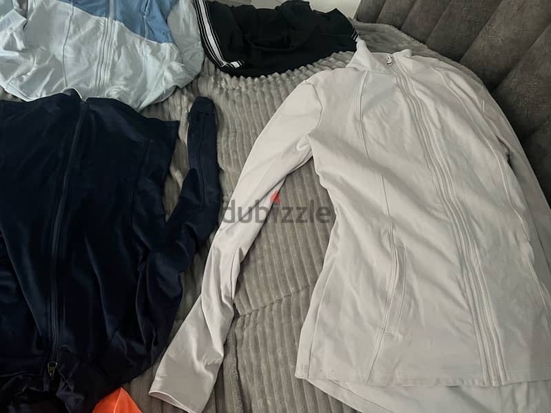 12 shirts  and 3 used like new gym sports shirts and pants size small 5