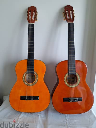 Two China Made nylong string small guitars with stands