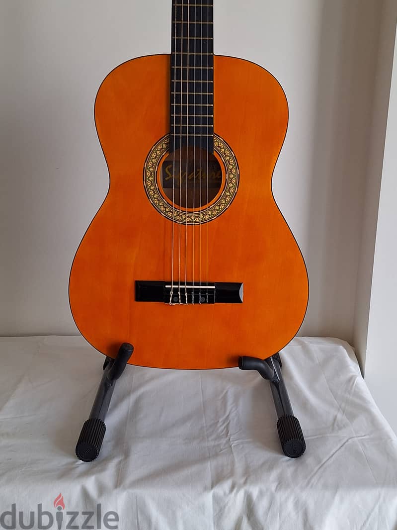 Two China Made nylong string small guitars with stands 2