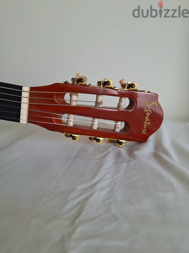 Two China Made nylong string small guitars with stands 3