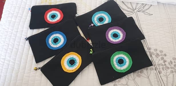 Black Evil Eye pouches with a zipper and charms