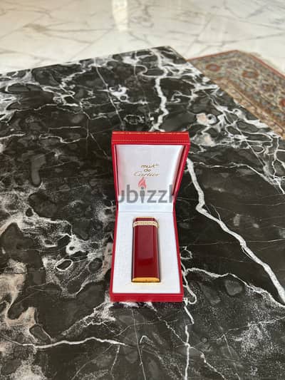 A 18K gold and red laque lighter, Cartier, with box