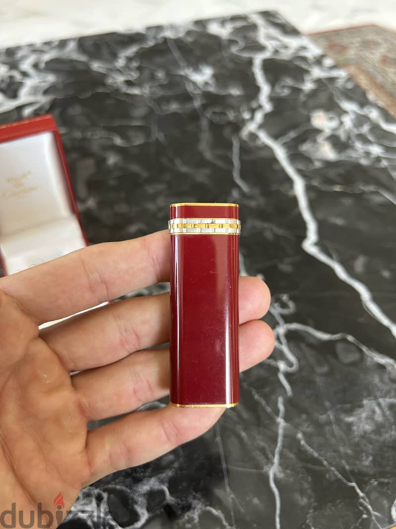 A 18K gold and red laque lighter, Cartier, with box 1