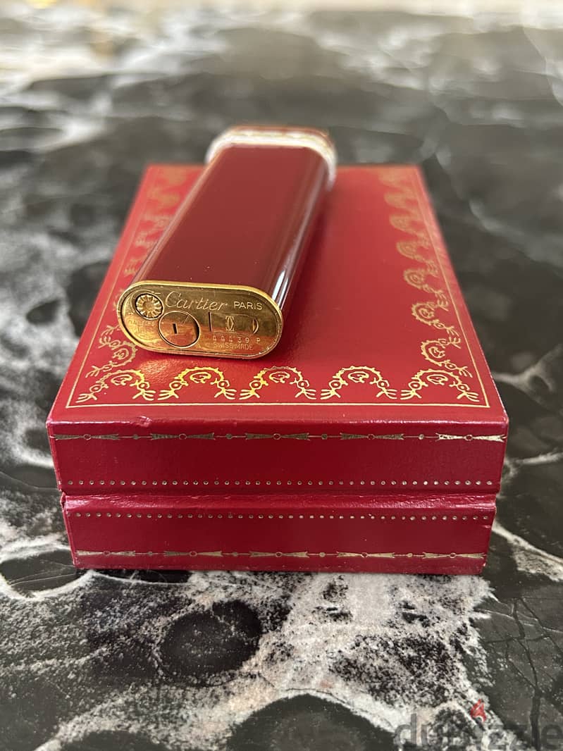 A 18K gold and red laque lighter, Cartier, with box 5