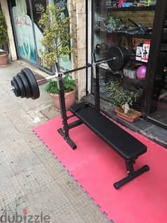 bench adjustable with adjustable rack with axe and weights all new 0