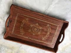 Wooden Tray with brass design pieces on it