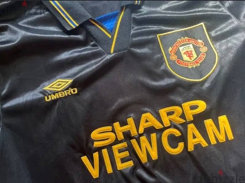 Green and gold, Cantona's last and the black Sharp Viewcam shirt