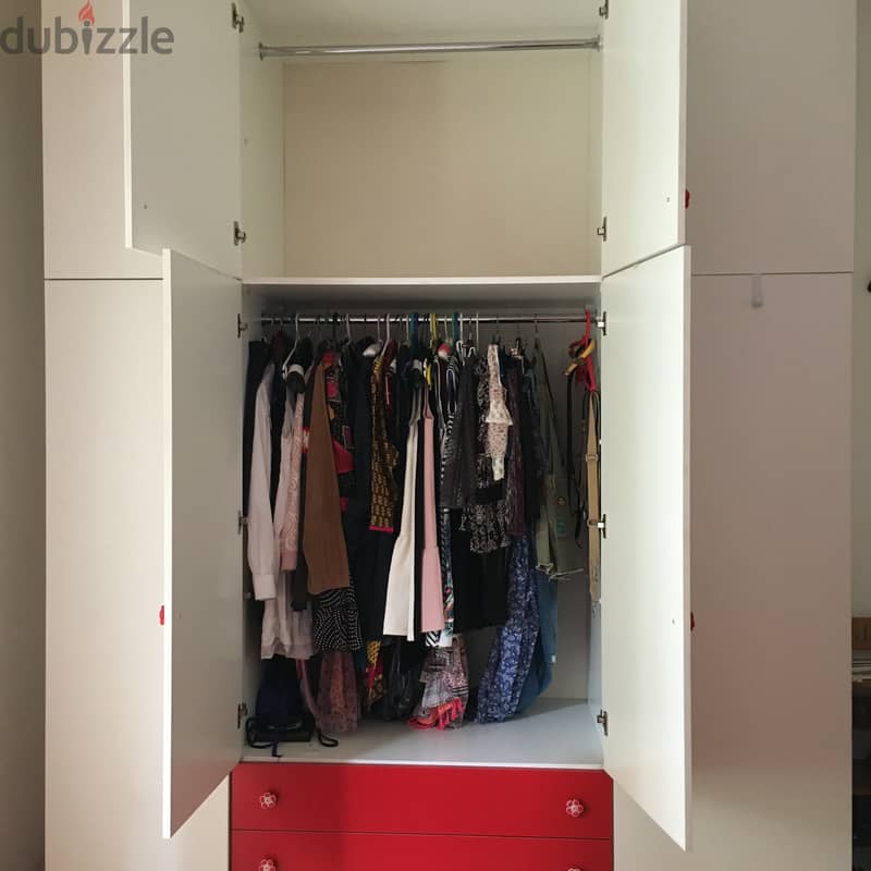 Closet for clothes with red bed for child bedroom. 1