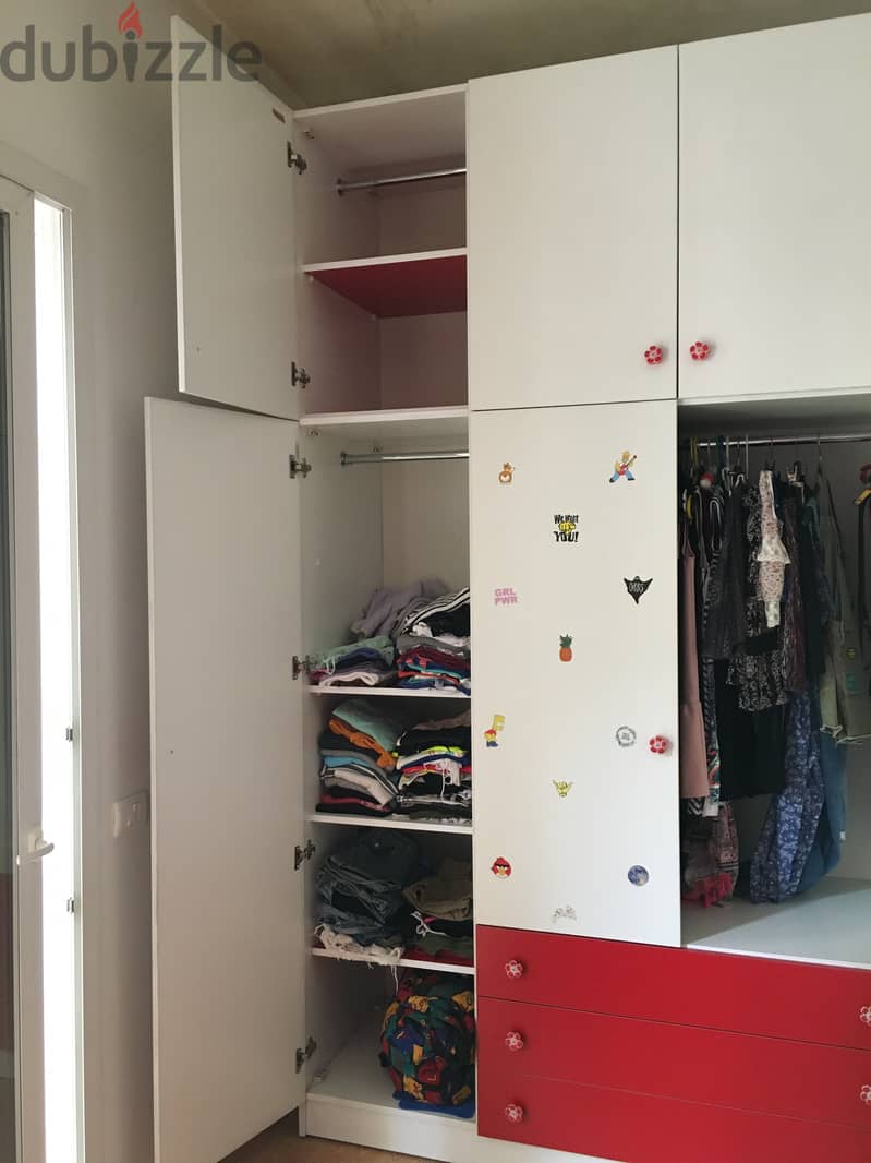 Closet for clothes with red bed for child bedroom. 2