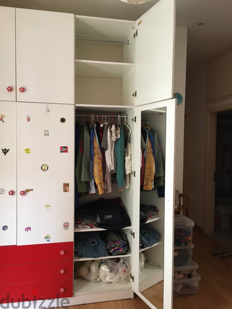 Closet for clothes with red bed for child bedroom. 3